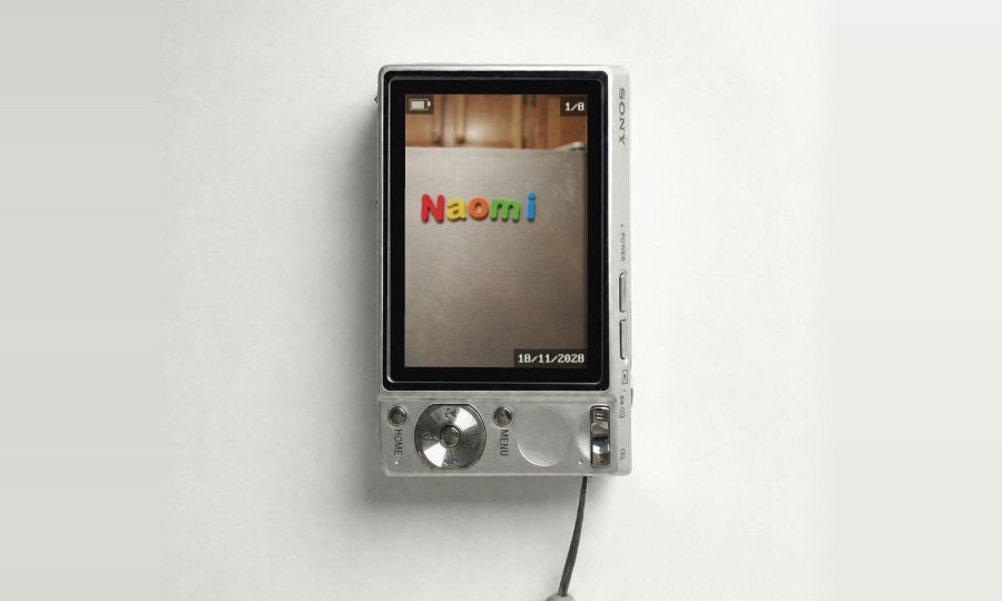 Baby Name Visualizer showing Naomi on fridge magnets inside its digital camera interface